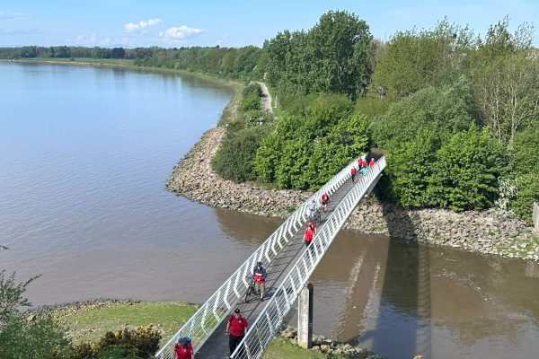 Giant Walkers going over Hale on Mersey bridge