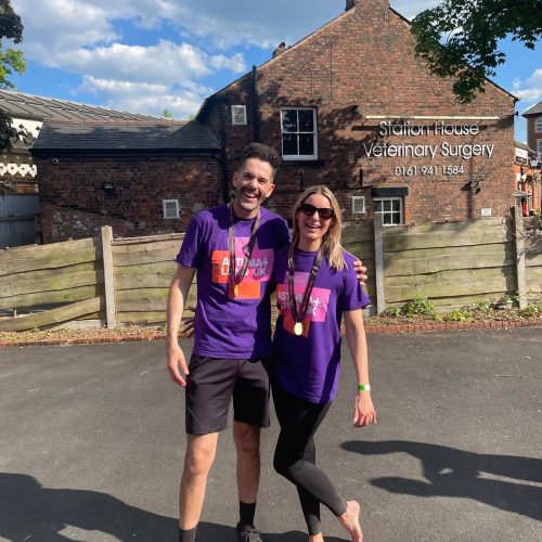 Walkers celebrating with medals after crossing the Giant Walk finish line in Hale (Manchester) 2025