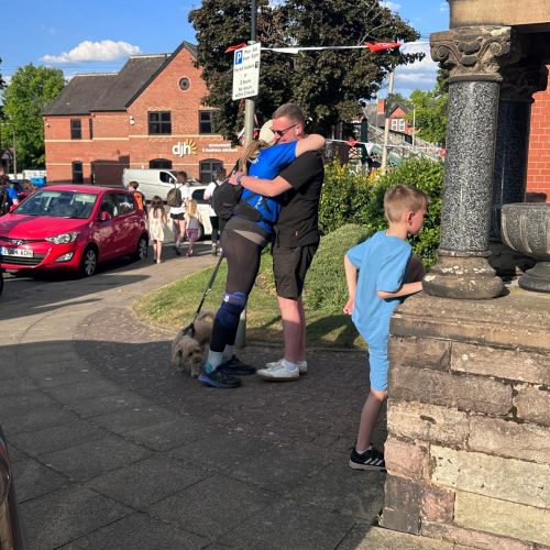 Walkers celebrating after crossing the Giant Walk finish line in Hale (Manchester) 2025