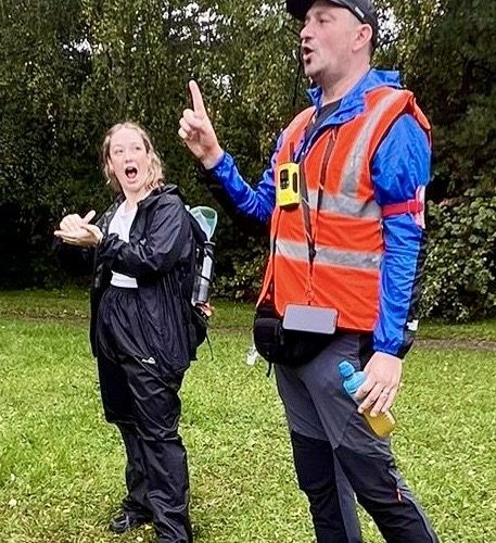 Marc Duschenes giving a safety briefing on the Giant Walk for CRY 2025 with a sign language translator assisting.
