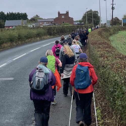 Trekkers walking through Hale on Mersey on the Giant Walk for CRY 2025.