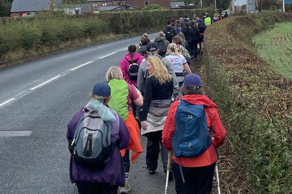 Trekkers walking through Hale on Mersey on the Giant Walk for CRY 2025.