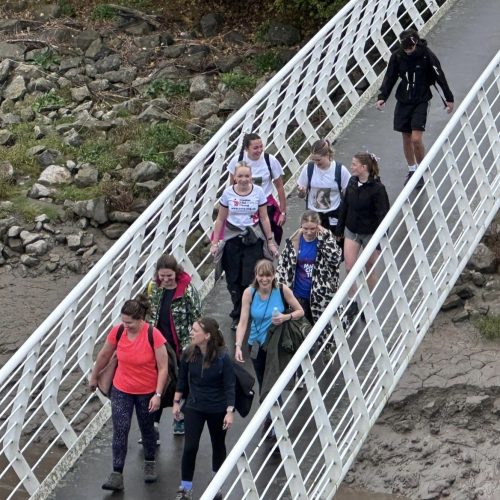 Trekkers walking across Hale on Mersey bridge on the Giant Walk for CRY 2025.