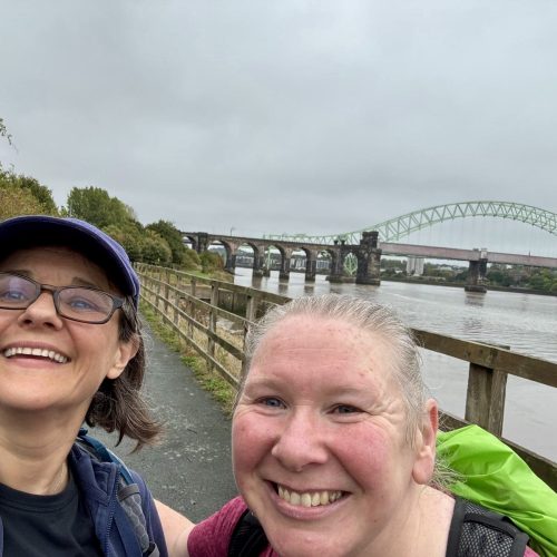 Trekkers walking along the waterside on the Giant Walk for CRY 2025 Hale2Hale.