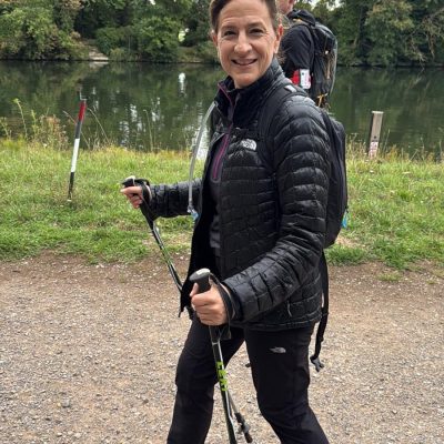 MyIsrael walker trekking along the waterside with walking poles.